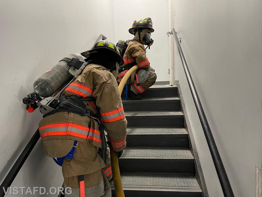Firefighters climbing the stairs